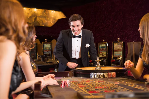A stylish woman beside vibrant slot machines displaying glowing sevens, showcasing the variety of top slots at TIKLUCK.