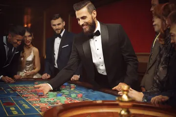 A close-up shot of golden coins falling around a spinning roulette wheel, representing immersive casino action at TIKLUCK.