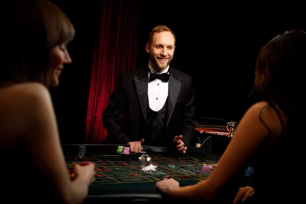 A player using their smartphone during a festive local event, representing TIKLUCK’s fully mobile-friendly casino.